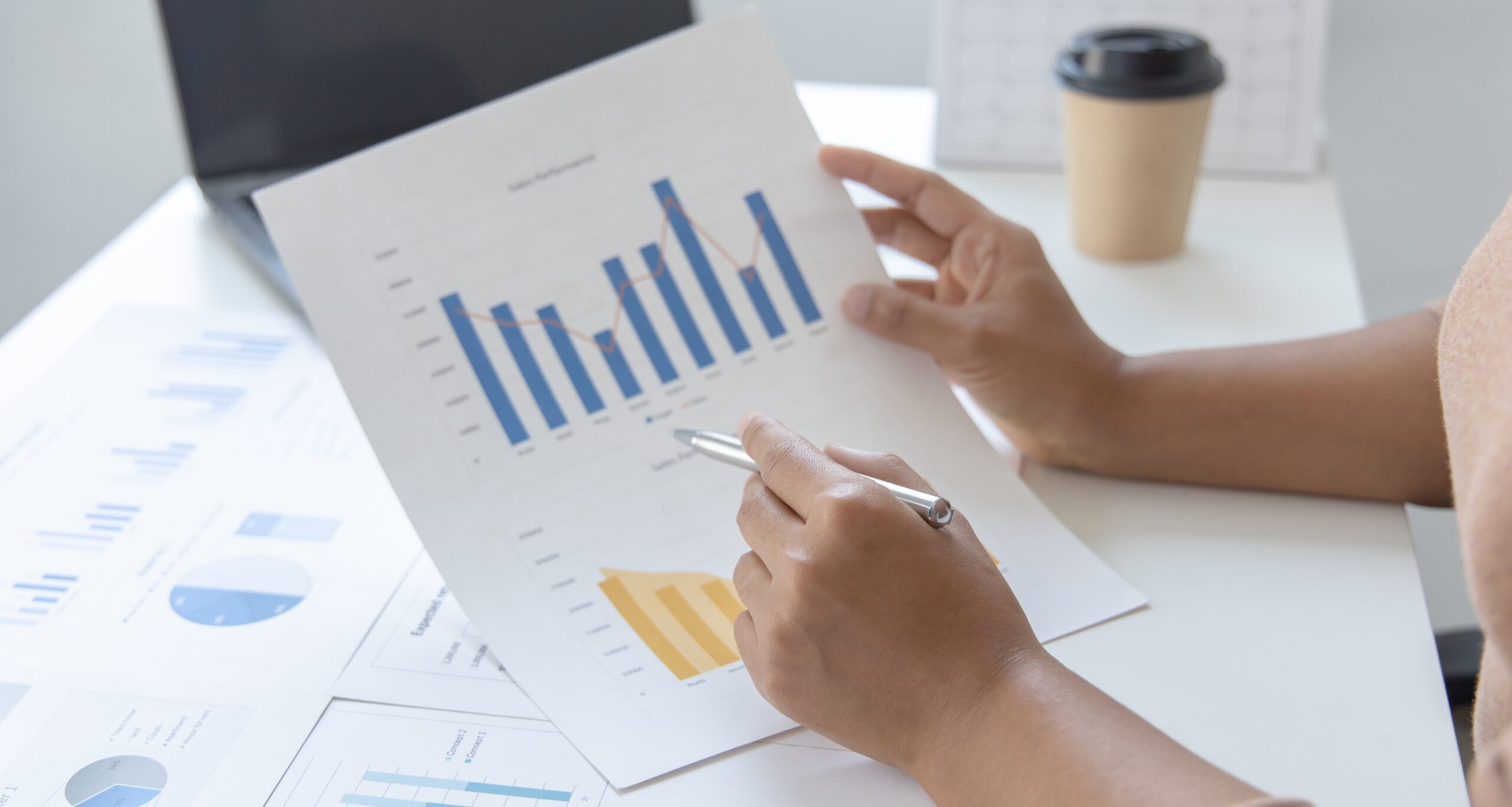 Financial businesswoman analyze the graph of the company's performance to create profits and growth, Market research reports and income statistics, Financial and Accounting concept.
