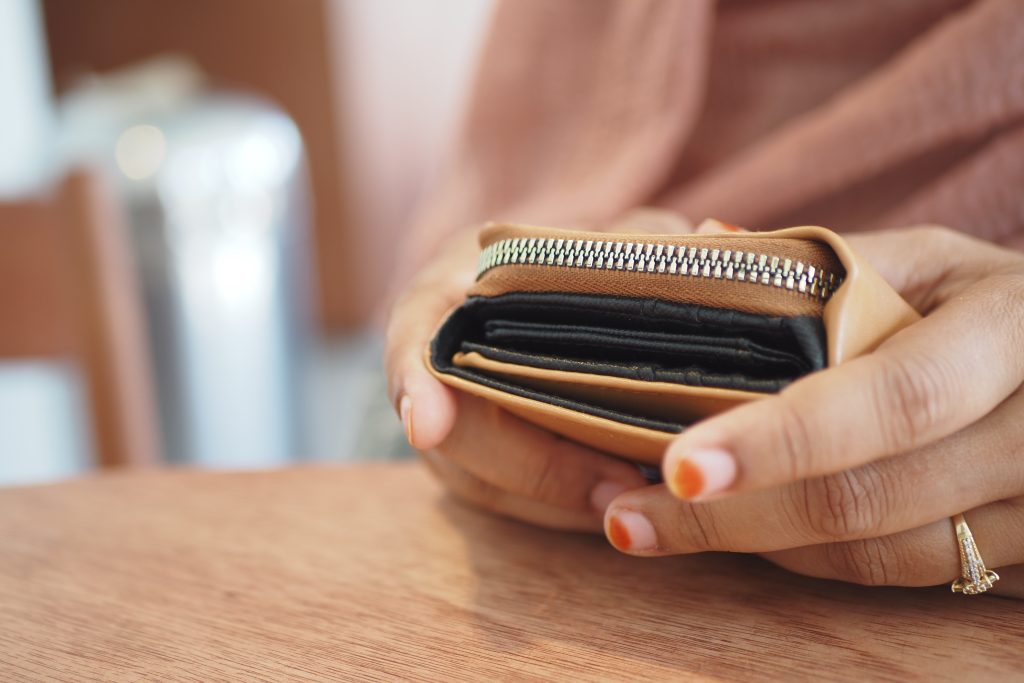 A closeup of a stylish wallet held in a hand, showcasing its intricate design and craftsmanship